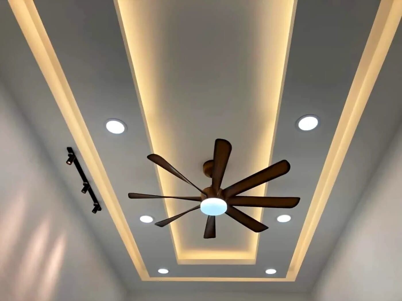 Completed plaster ceiling with cove lighting, downlights and a ceiling fan in a Malaysian home