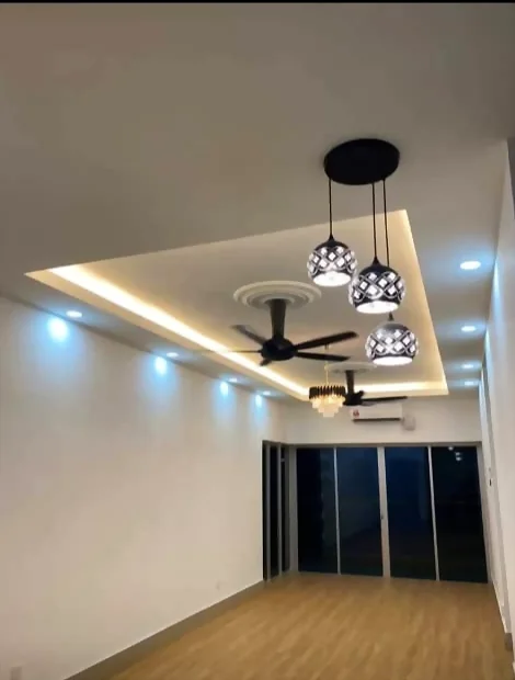 Chandelier, ceiling fan and downlights installed in a living area by Renovix Home Services in Kuala Lumpur.